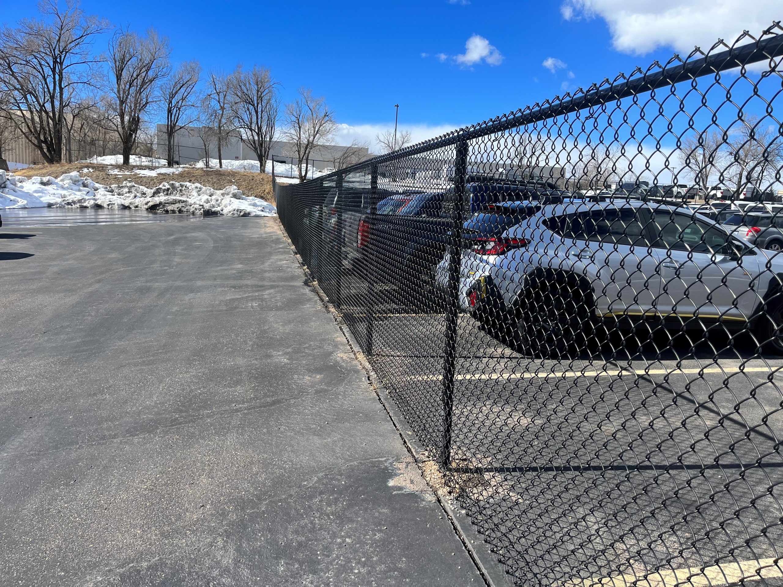 black chain link fence in parking lot