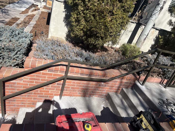 Custom metal handrails installed on a residential Denver stairway for safety and style