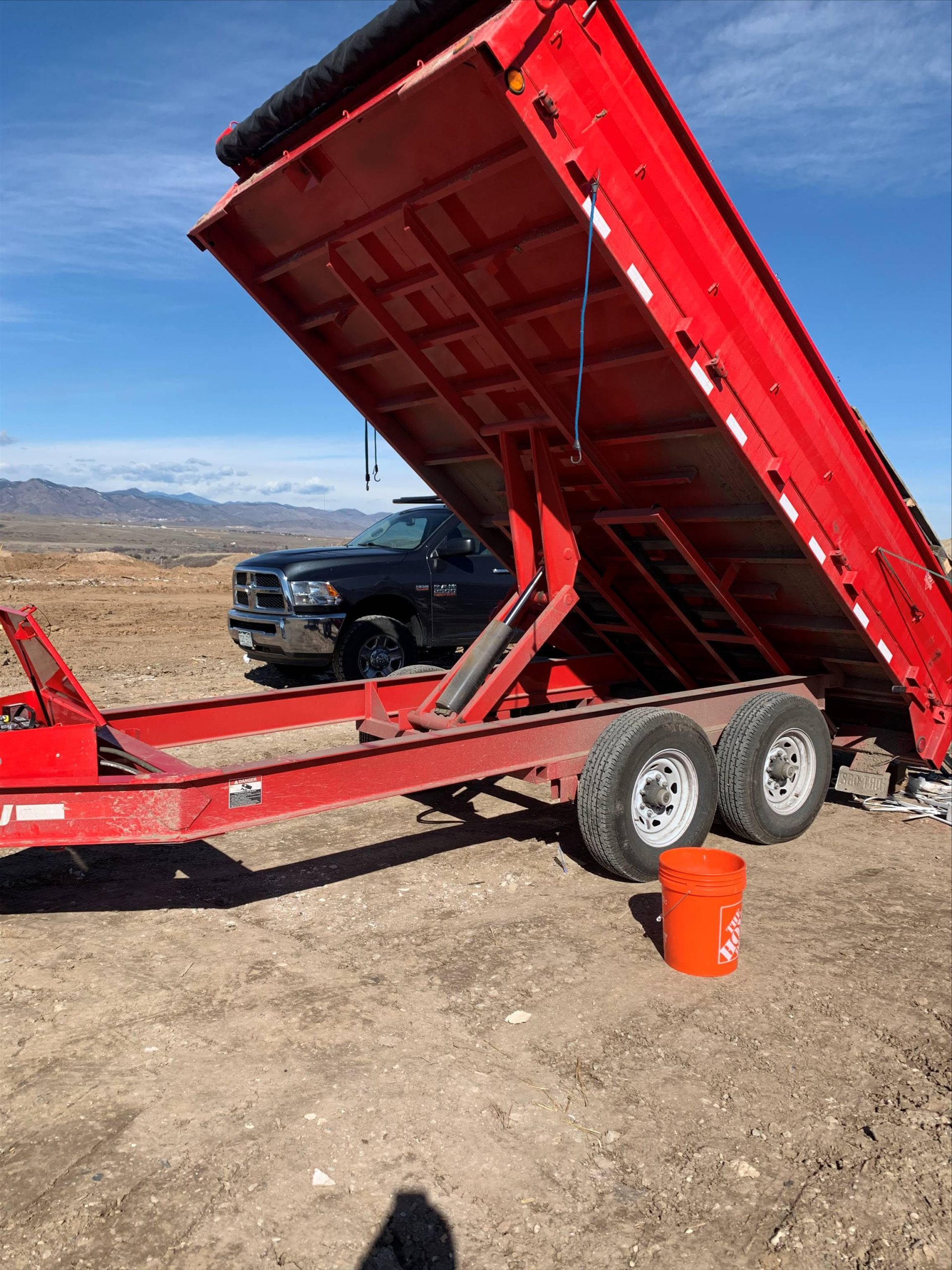 Work trucks and equipment staged at a commercial fence repair job site in the Denver metro area