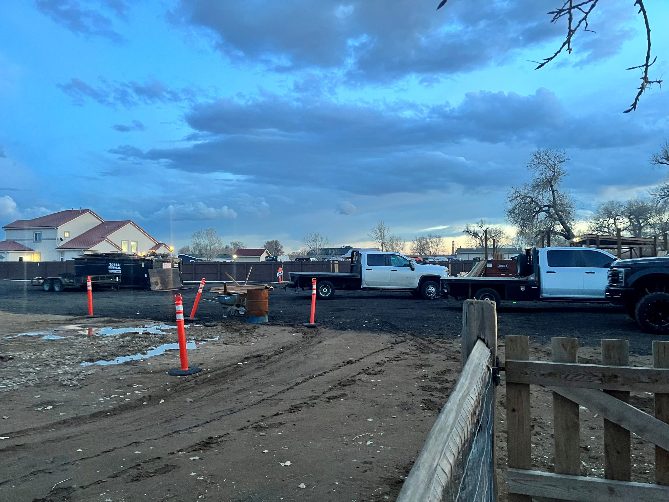 Commercial fence repair project underway in a Denver residential community with visible equipment and crew activity