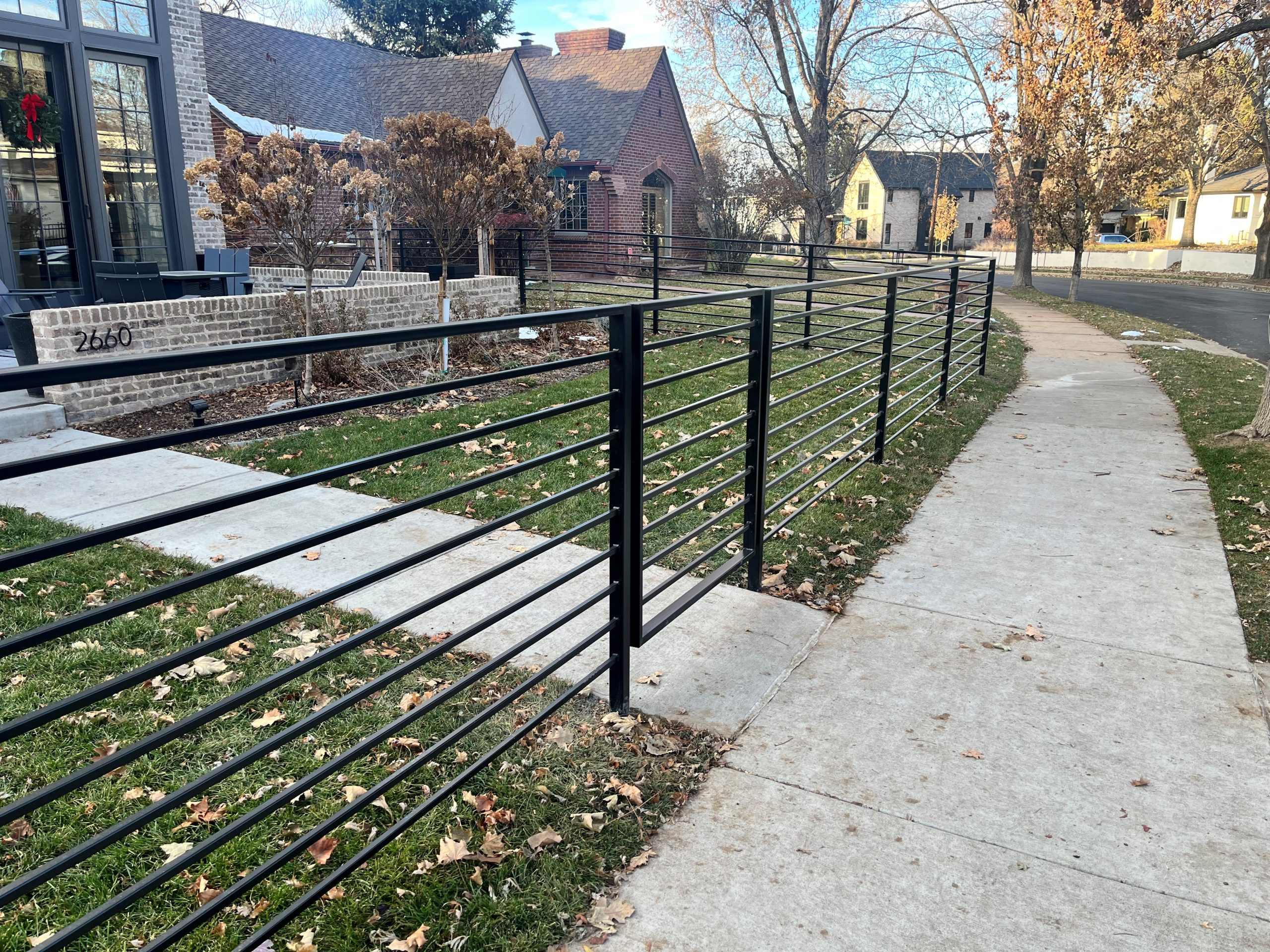 Custom fabricated black metal fence installed at a Denver-area home