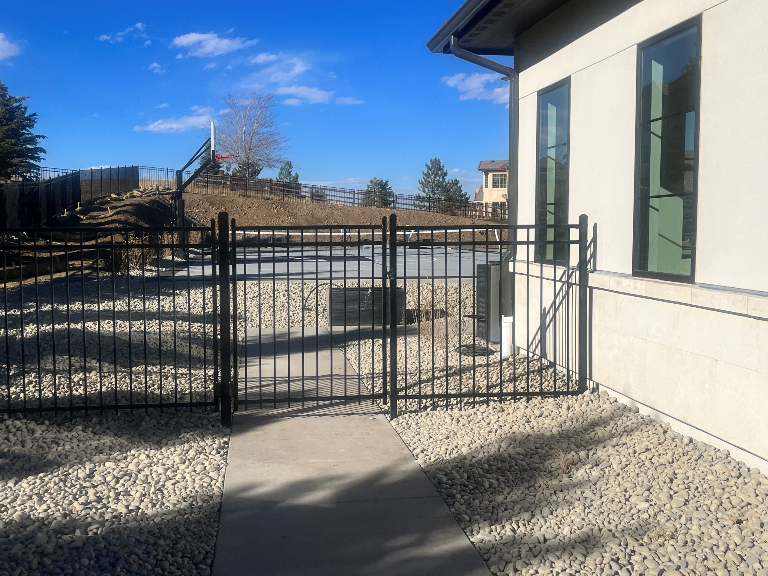 Custom black metal gate and fence fabricated for a modern Denver home