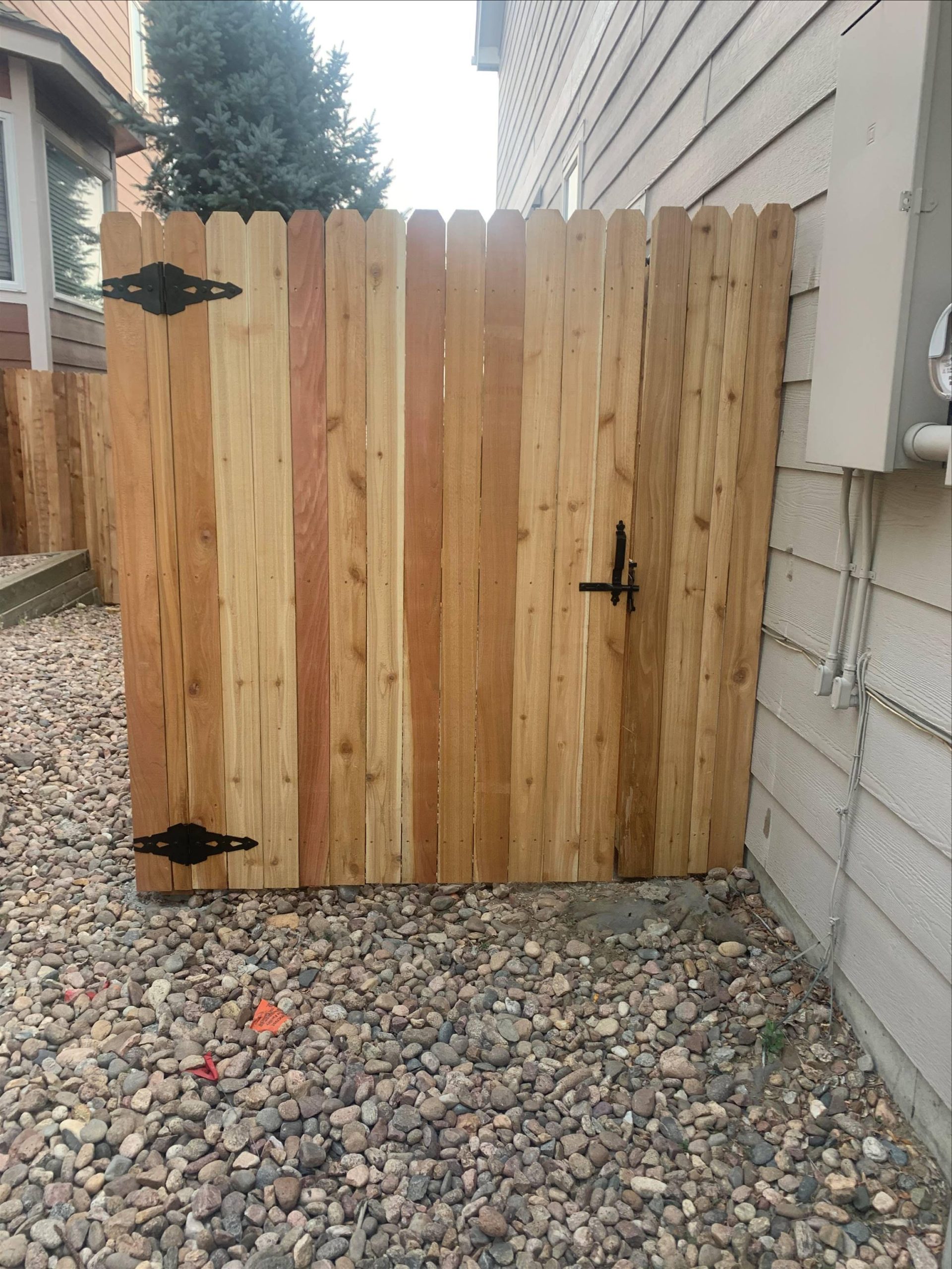 Custom residential fence gate with wood privacy design and black hardware in Denver