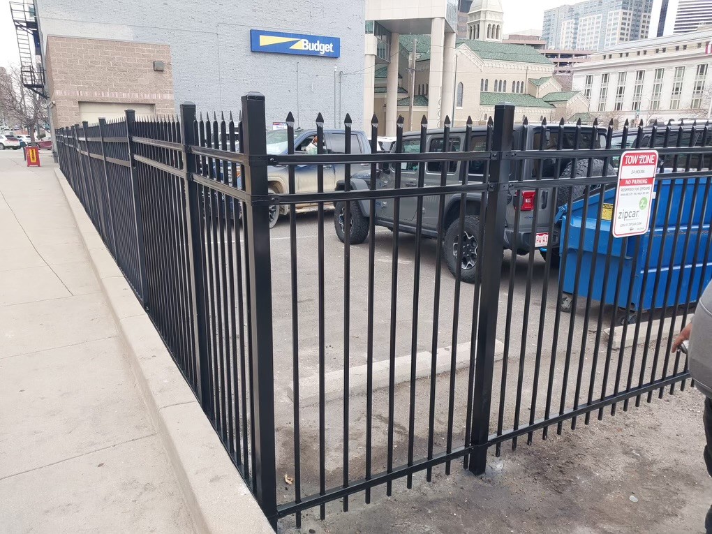 Decorative steel ornamental fence panels with spear-top pickets installed at a Denver area commercial business