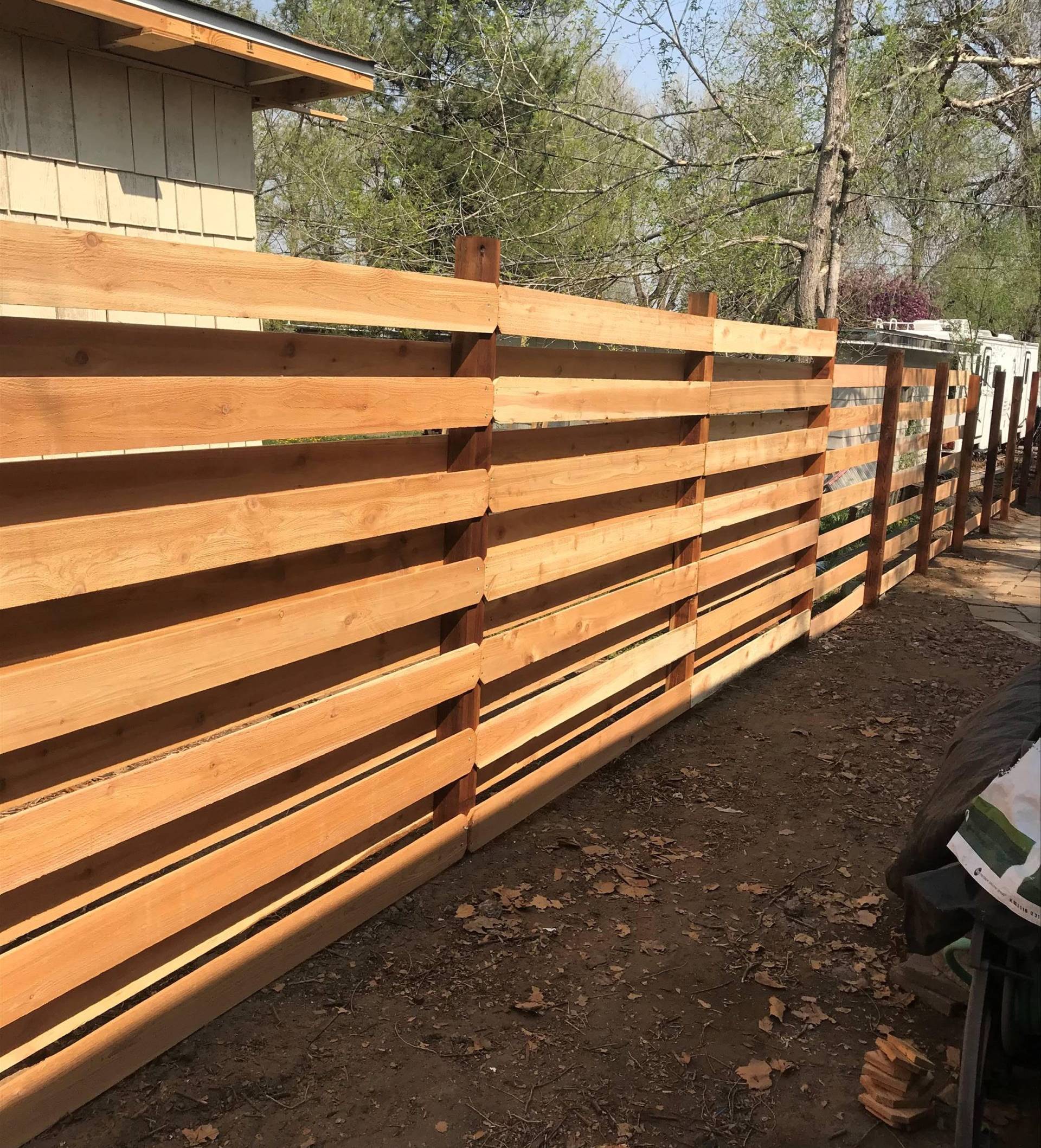 Custom wood fence installation designed for unique Denver backyard layout
