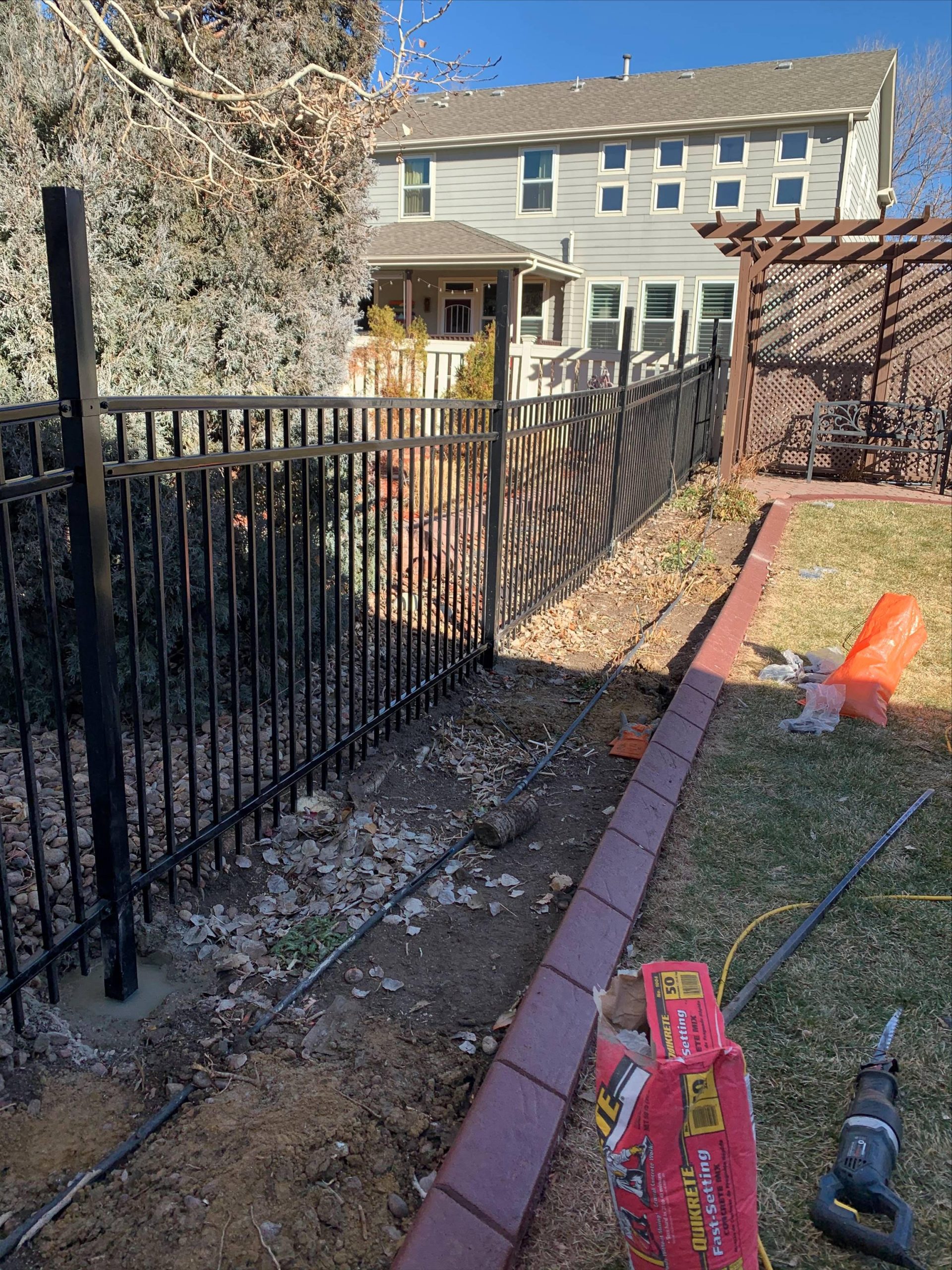 Steel ornamental fence installed along residential property line in Denver