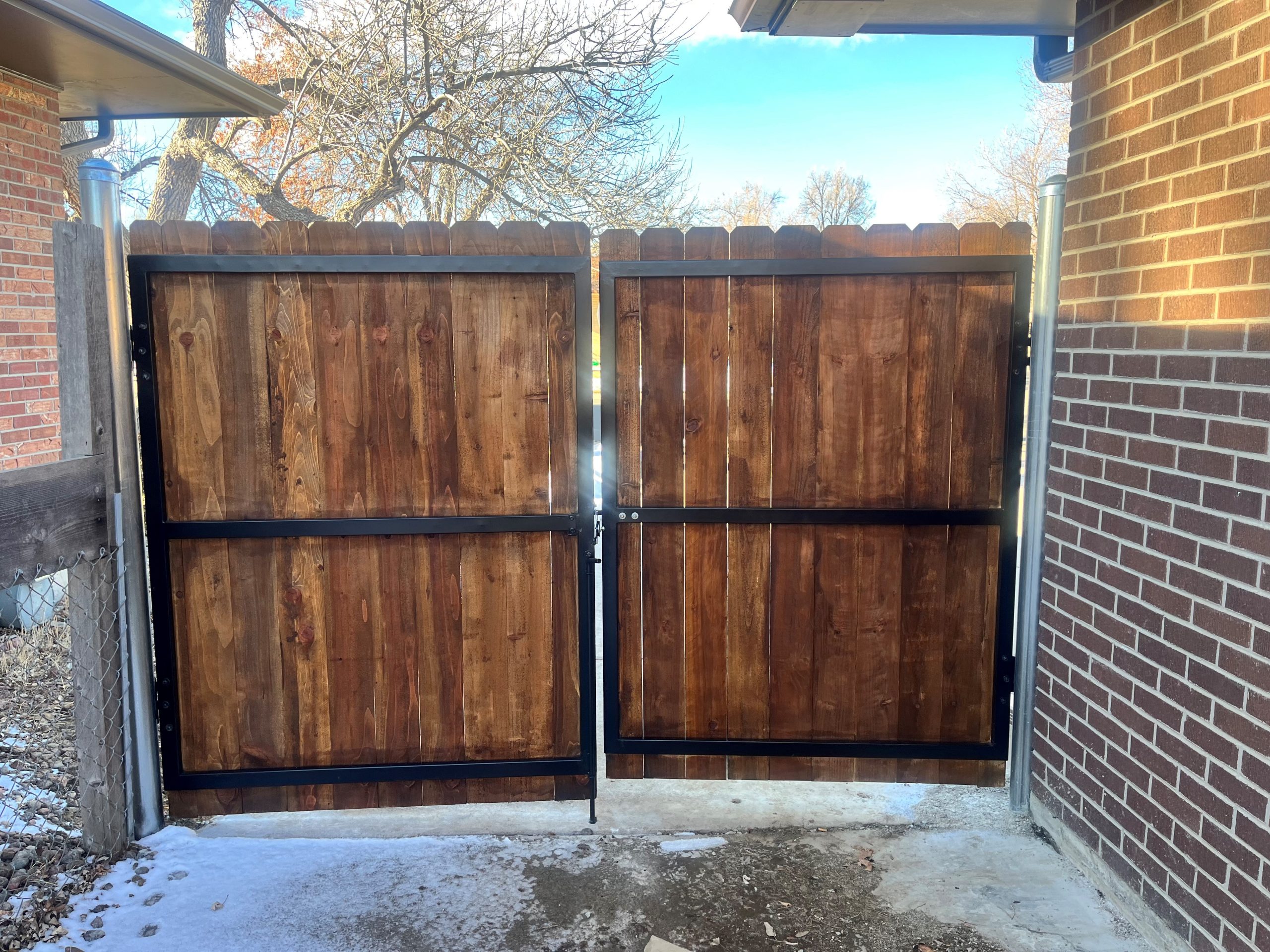 Completed custom residential fence gate installation in Denver backyard