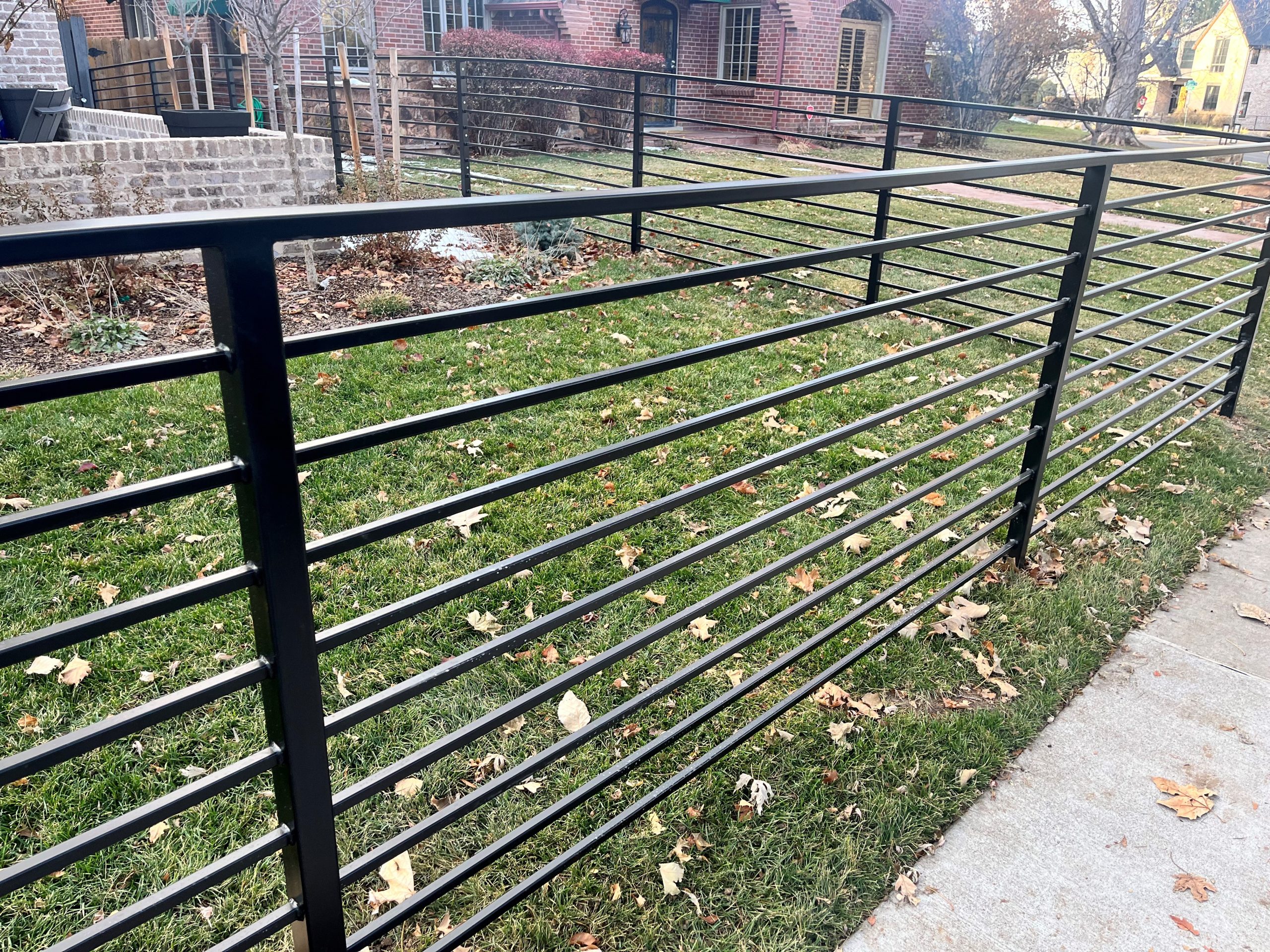 Modern metal fence installation at a residential property in Denver