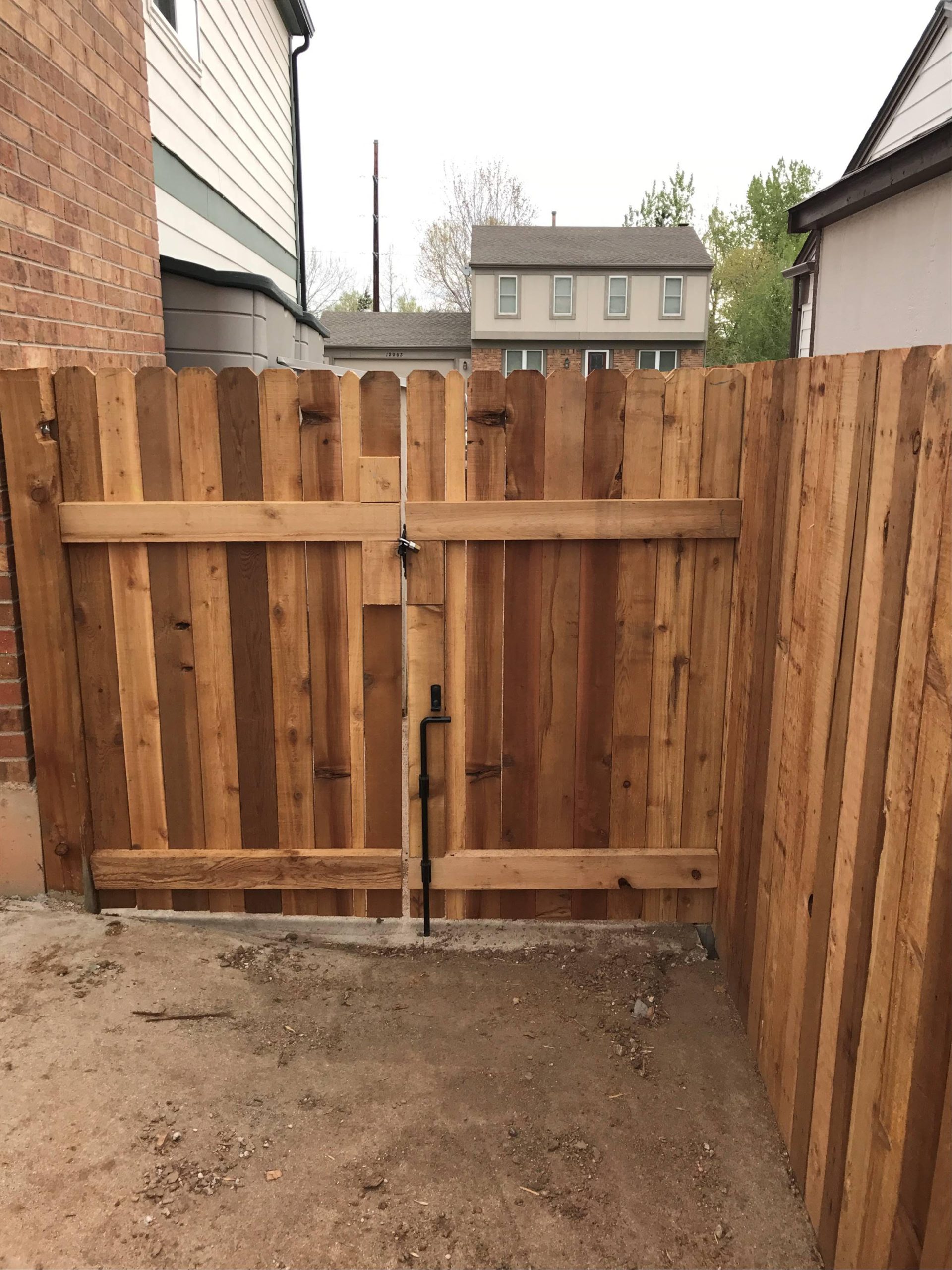 Wood privacy fence gate installed in a residential backyard in Denver with secure latch and hardware