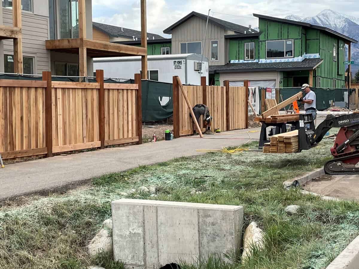 Residential wood fence repair project in Denver with contractor rebuilding fence pane