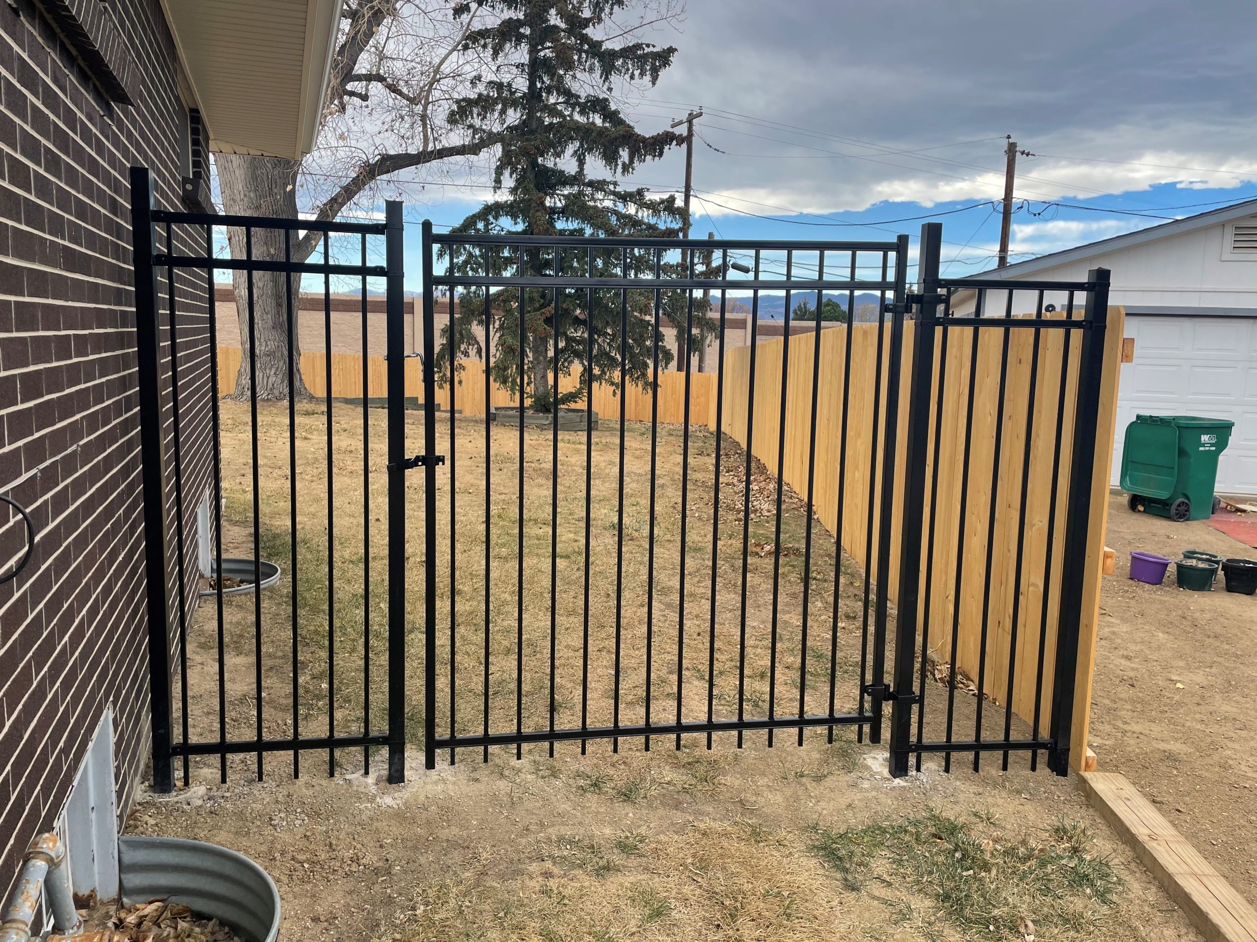 Steel ornamental fence with matching gate installed on a residential property in Wheat Ridge CO