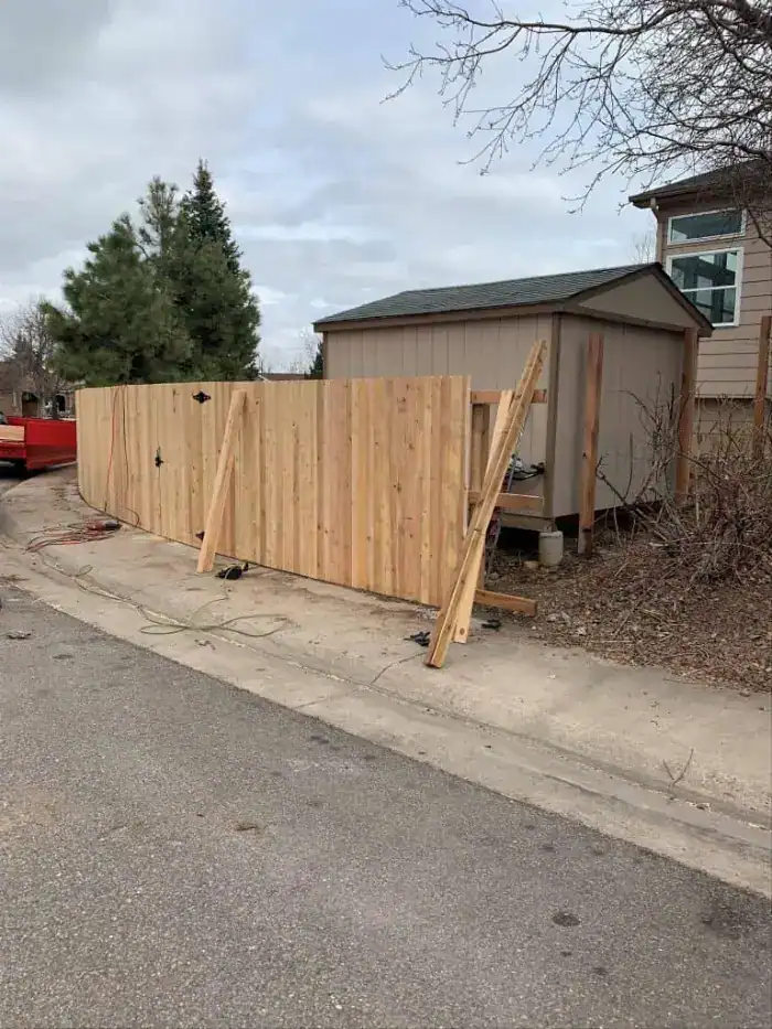 Wood privacy fence installation in a Denver-area residential backyard
